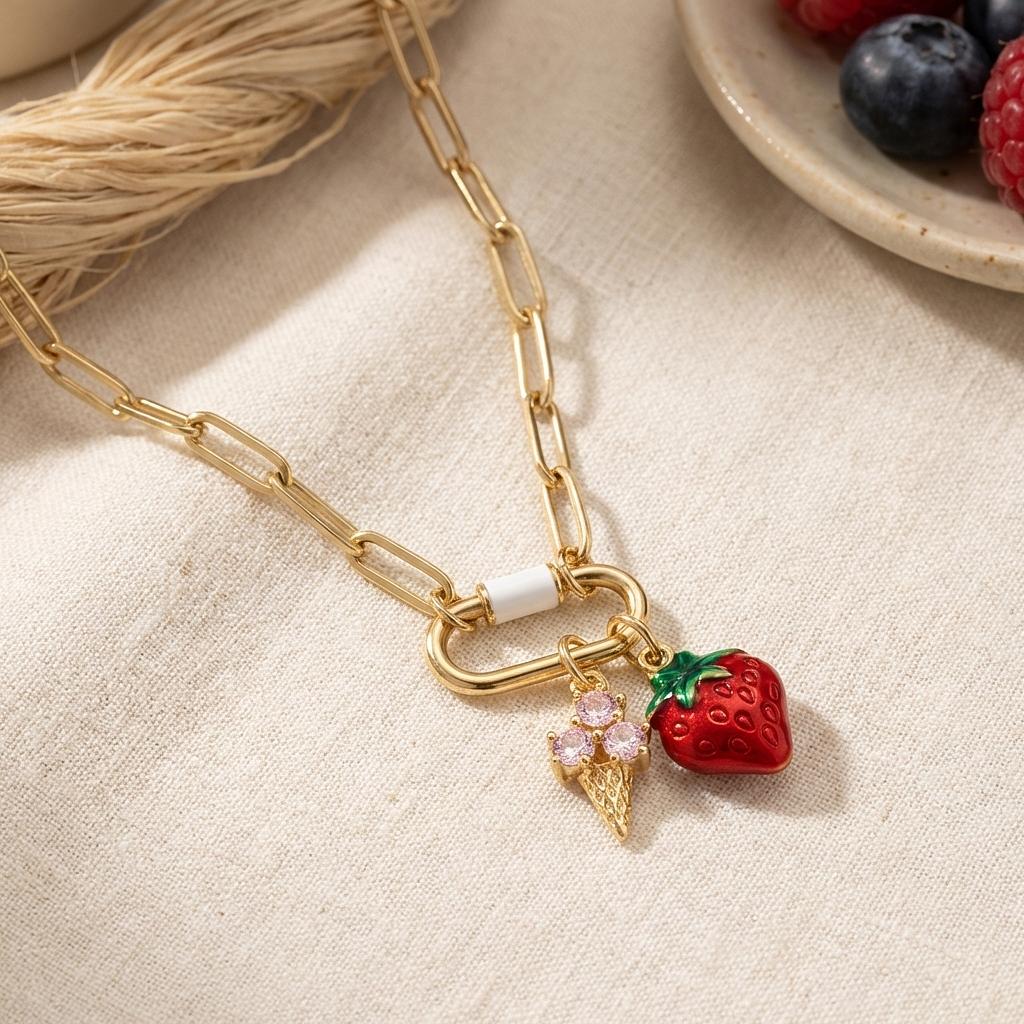 Gold enamel strawberry ice cream cone charm from Winks Design Studio, LLC, featuring vibrant red and gold summer jewelry design.
