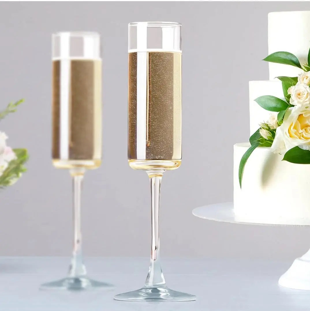 Custom engraved champagne flute by Winks Design Studio, LLC, showing a sleek glass with personalized etched design on the stem.