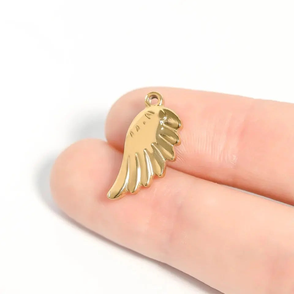 18K gold angel wing charm from Winks Design Studio, LLC, featuring detailed wing design and polished finish.
