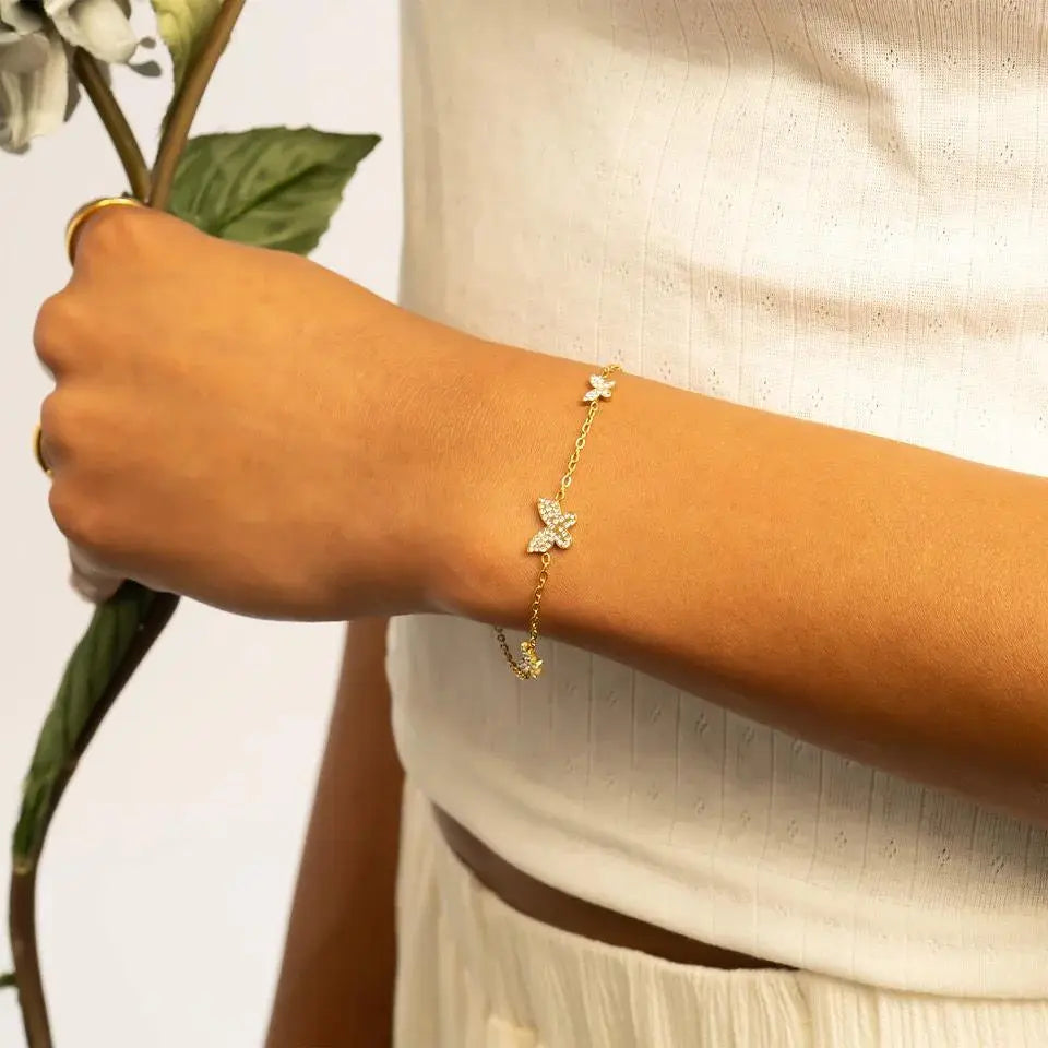 Gold stainless steel butterfly bracelet featuring charm design, crafted by Winks Design Studio, LLC.