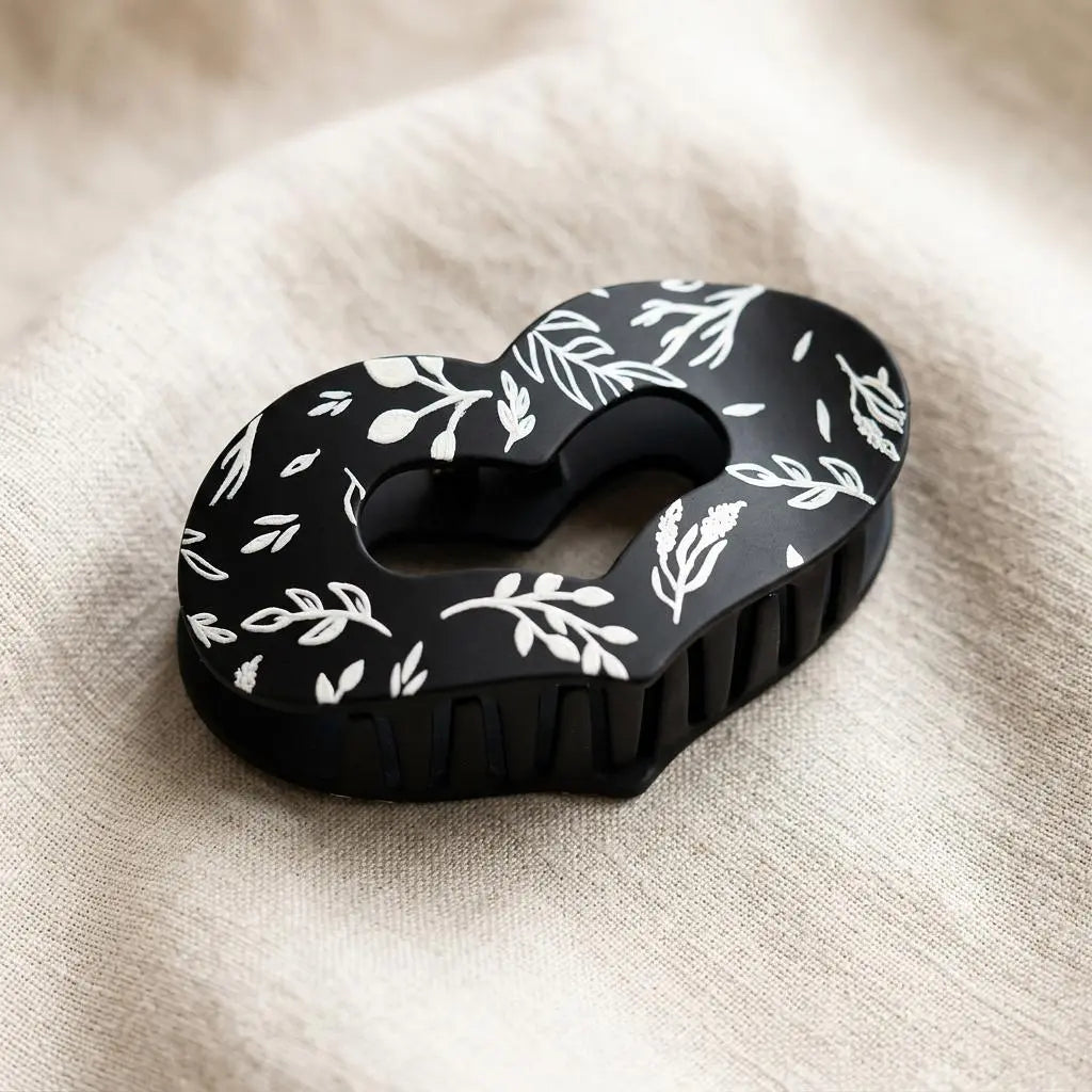 Sage and stem heart-shaped claw clip by Winks Design Studio, LLC, showcasing its decorative design and sturdy clasp.