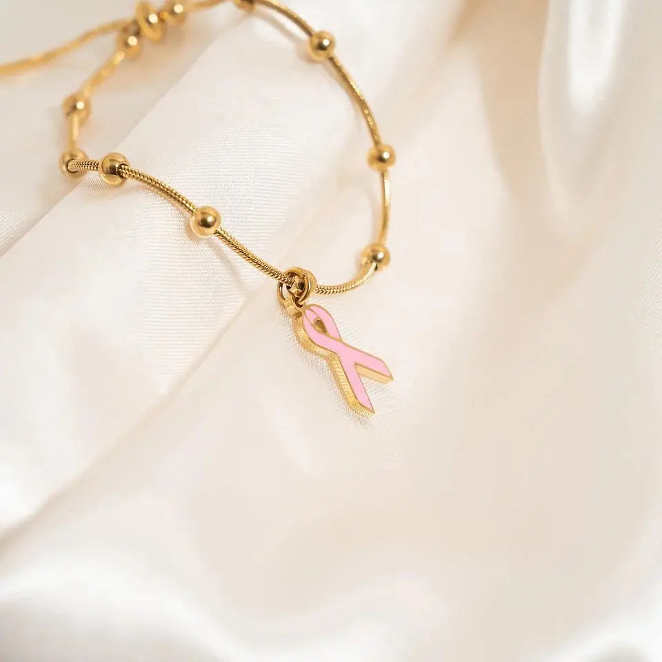 18K gold adjustable bangle bracelet with cancer ribbon charm, designed by Winks Design Studio, LLC.