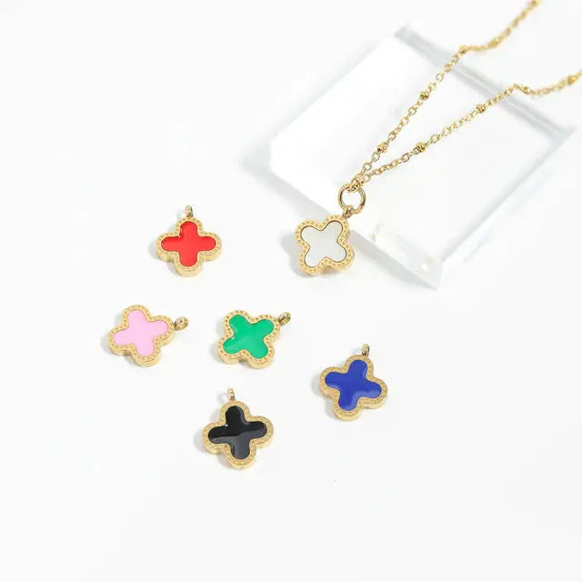 Gold lucky clover charm from Winks Design Studio, LLC, featuring a detailed four-leaf clover design on a shiny gold surface.