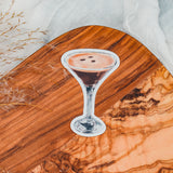 a painting of a drink sitting on top of a wooden table