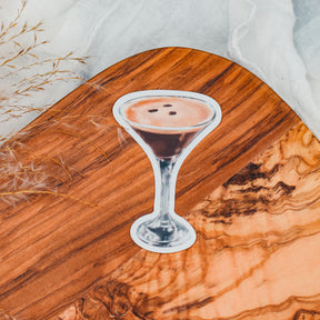a painting of a drink sitting on top of a wooden table