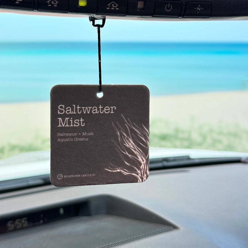 Winks Design Studio Milkhouse Candle Co. Car Freshener in Saltwater Mist scent, hanging with a sleek design and refreshing fragrance.