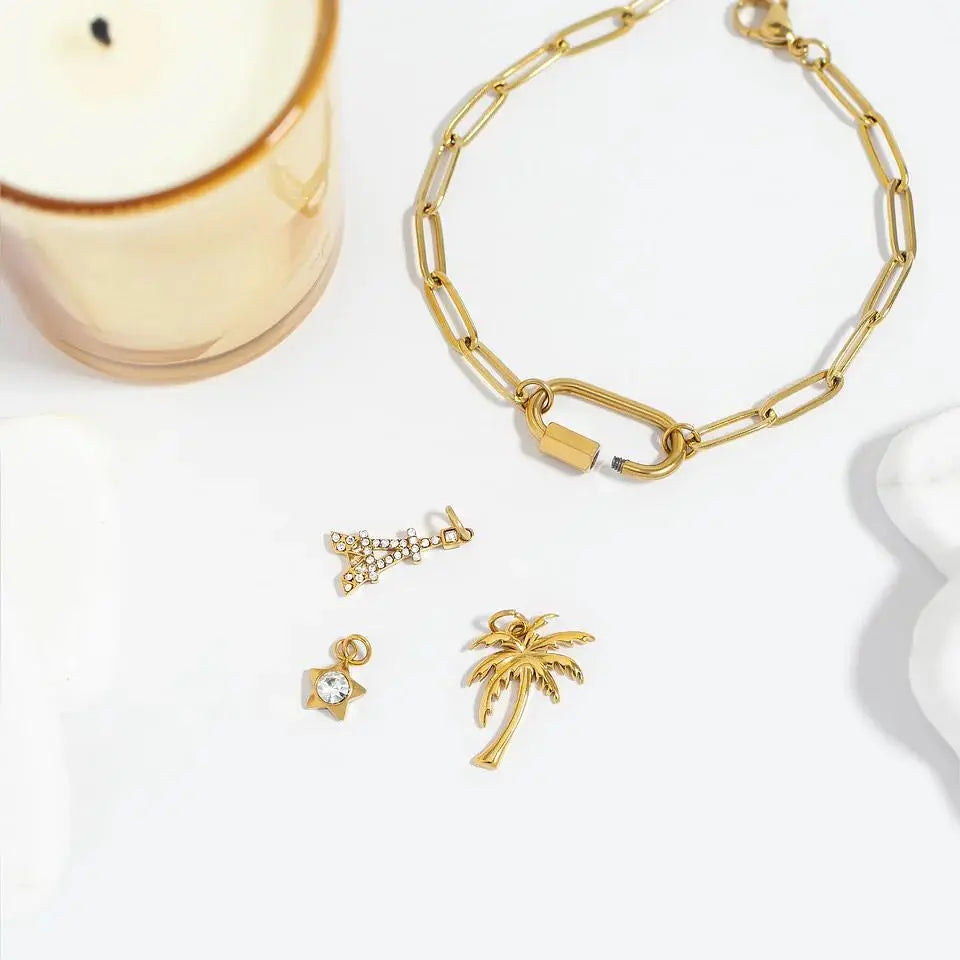 18K gold paperclip carabiner bracelet by Winks Design Studio, LLC featuring sleek interconnected links and a secure clasp.