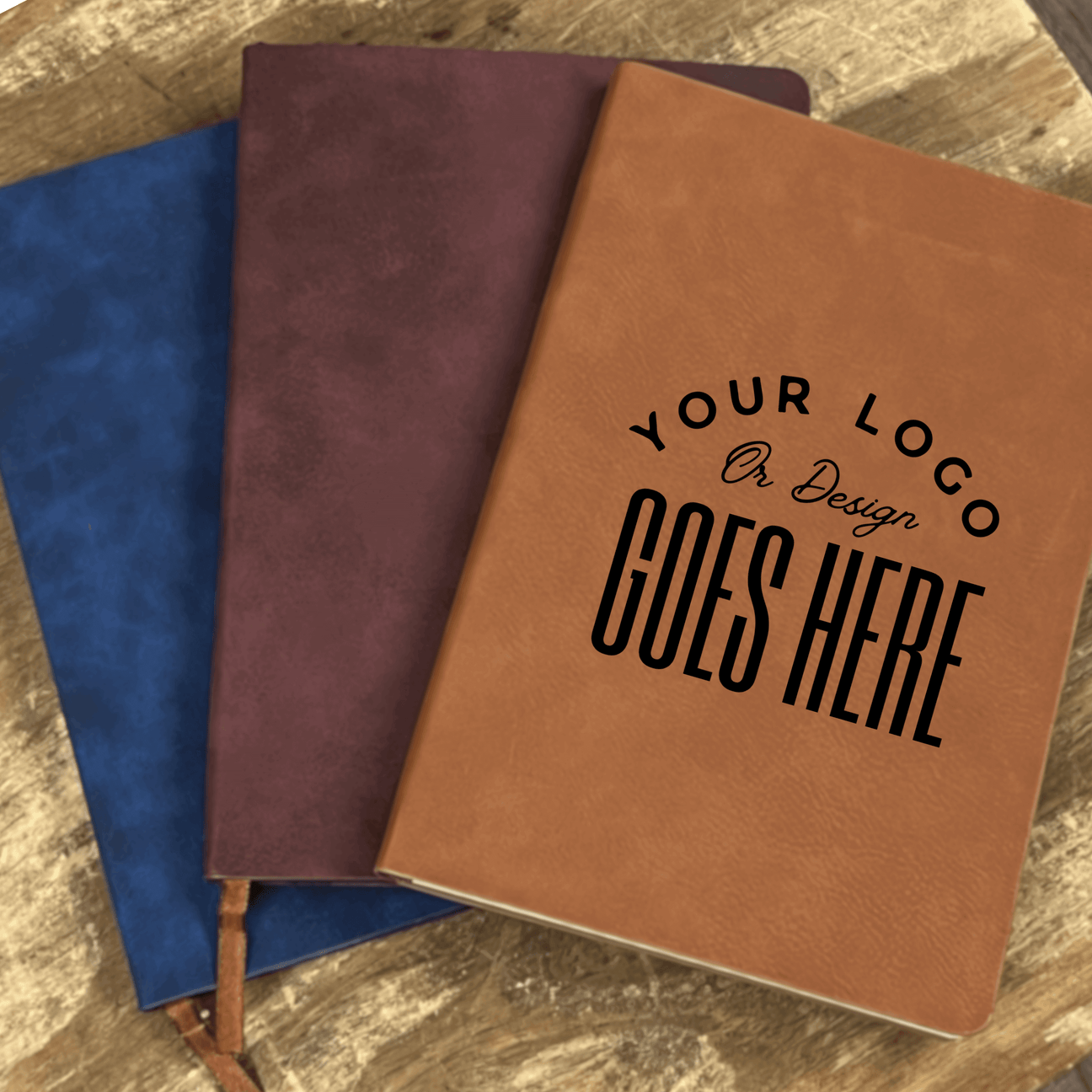 Custom engraved leather journals in various colors with personalized logo design option on the cover.