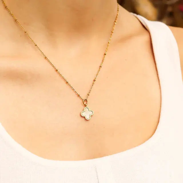 Gold lucky clover charm by Winks Design Studio, LLC, featuring a detailed four-leaf clover design on a smooth gold finish.
