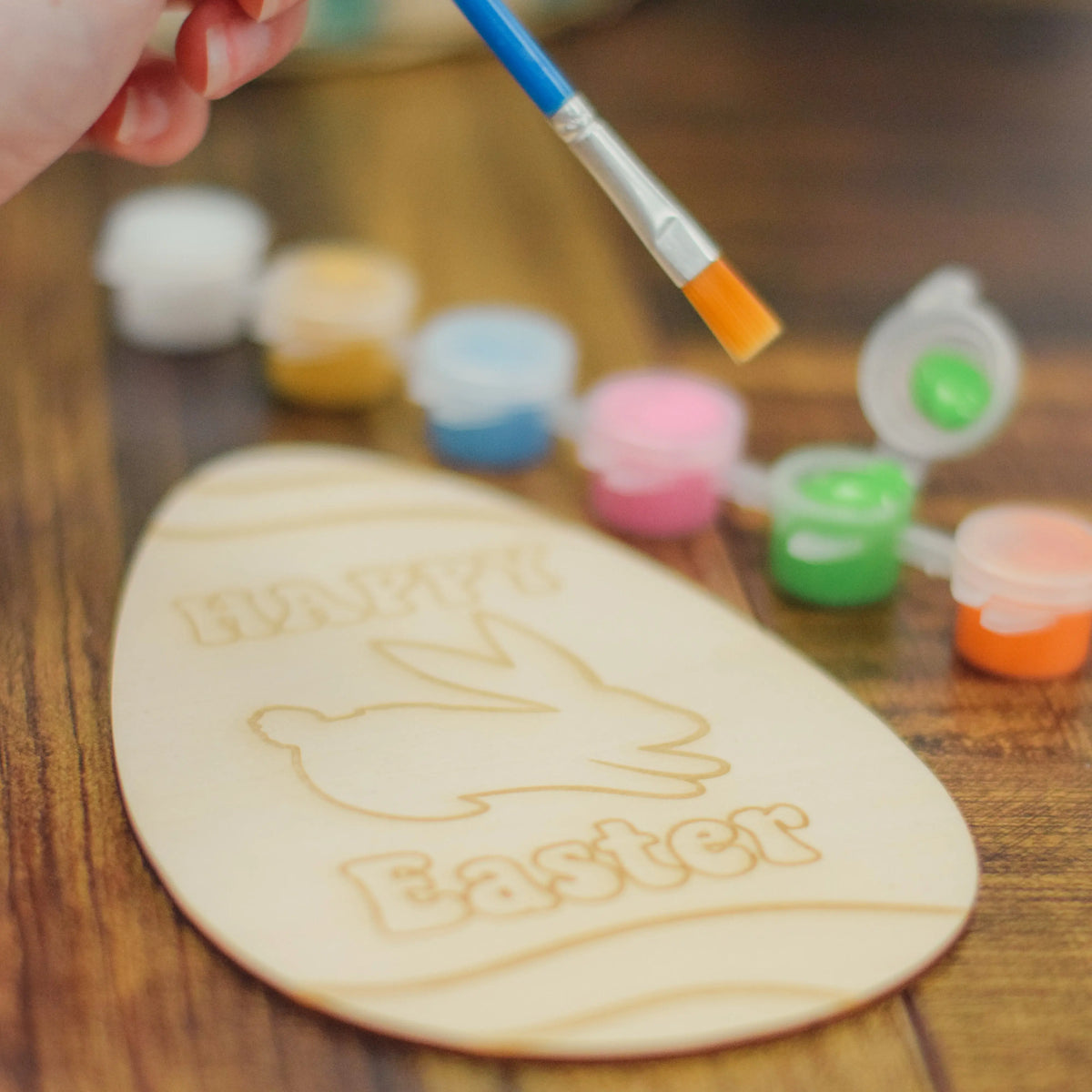 Kids half dozen egg painting workshop by Winks Design Studio, LLC showing colorful eggs and art supplies for children.