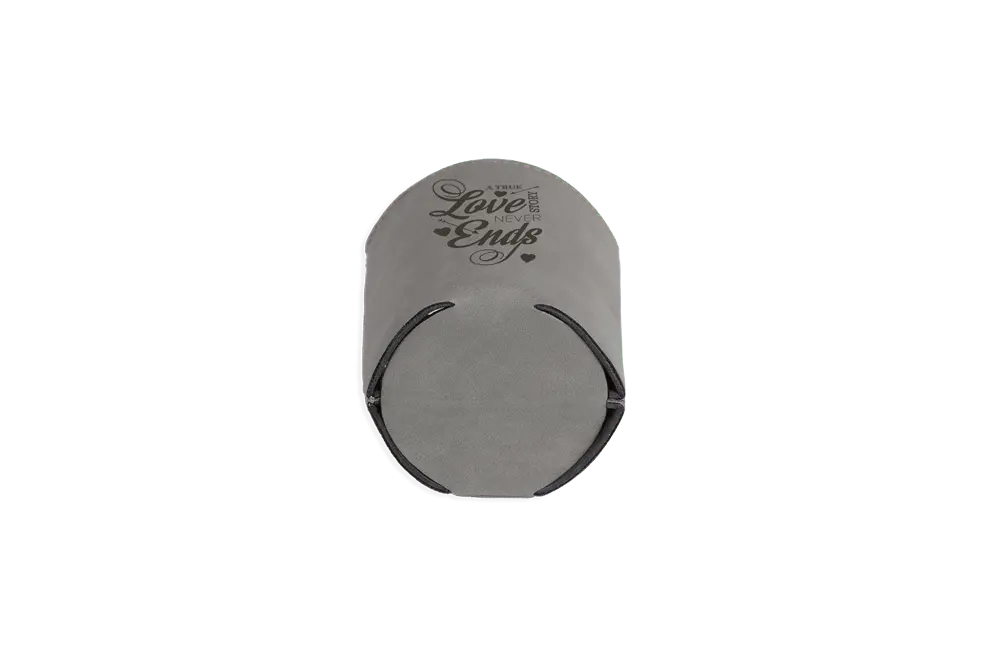 Gray custom leather can sleeve with engraved design from Winks Design Studio, LLC, showcasing a stylish and durable can holder.