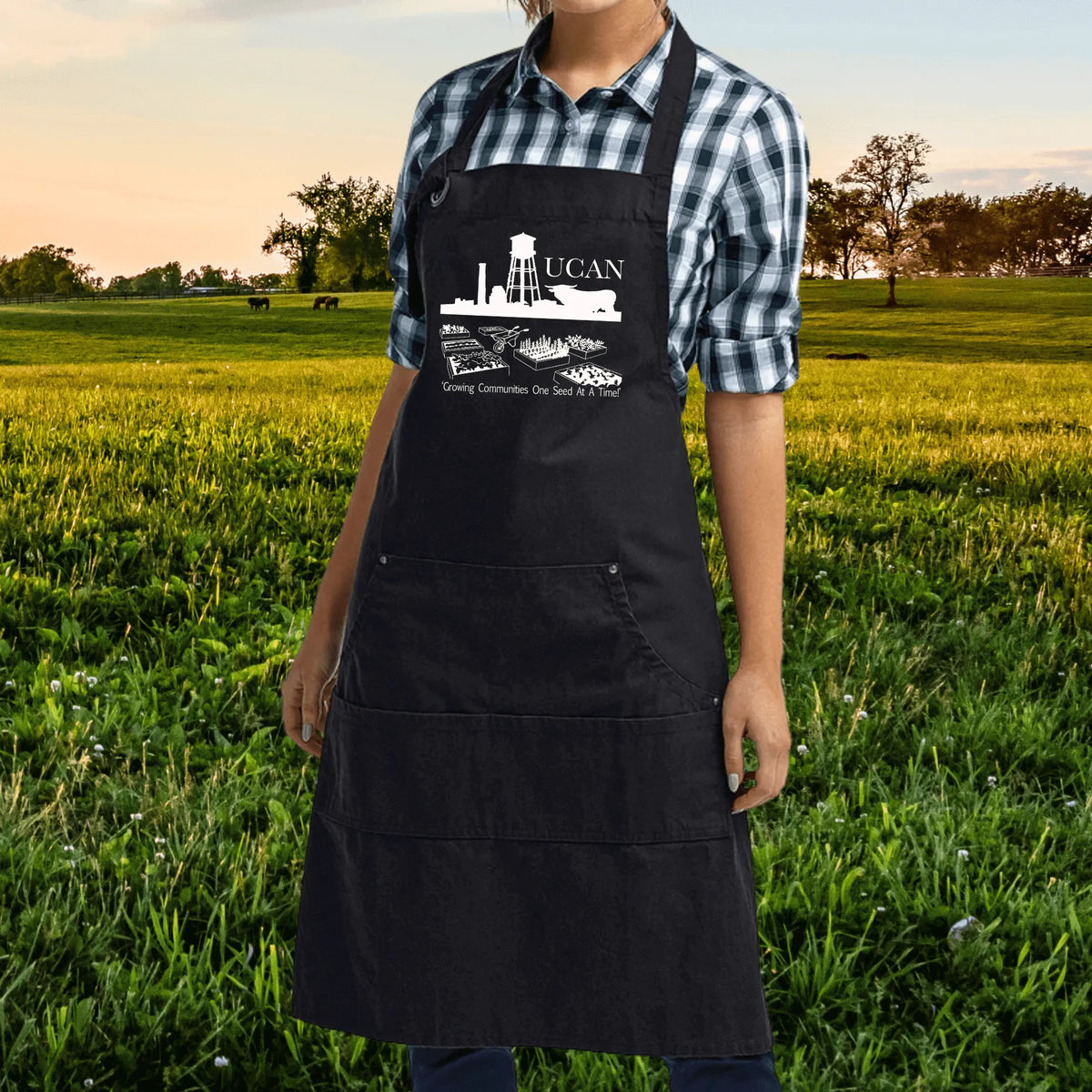 Black UCAN Pocketed Garden Apron by Winks Design Studio, LLC, with multiple front pockets and adjustable straps.