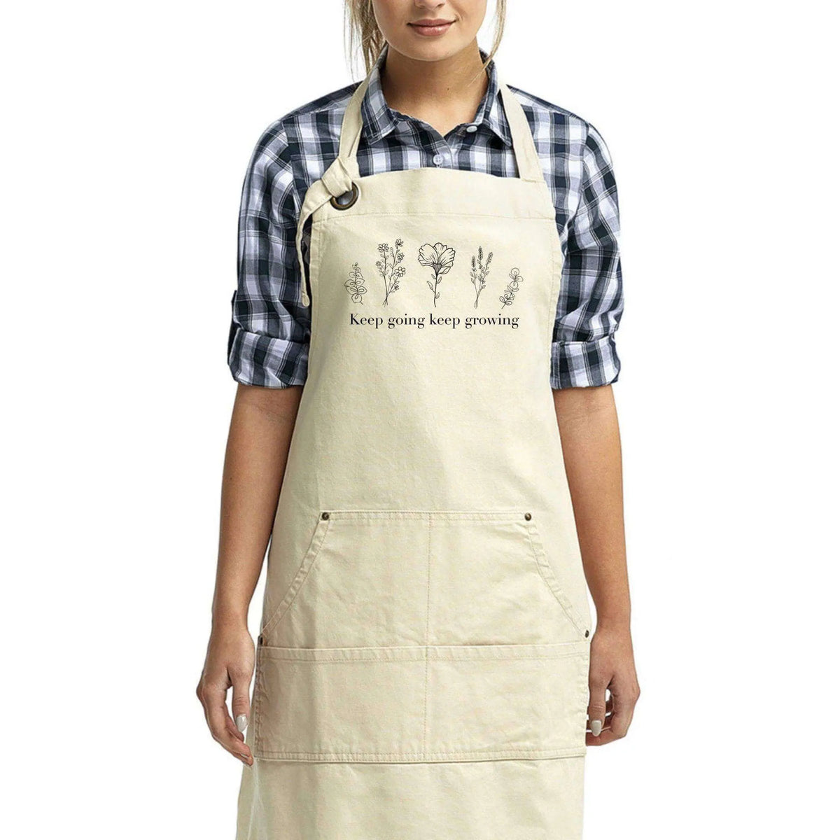 Winks Design Studio LLC Keep Going Keep Growing apron with motivational text, denim fabric, and adjustable neck strap.