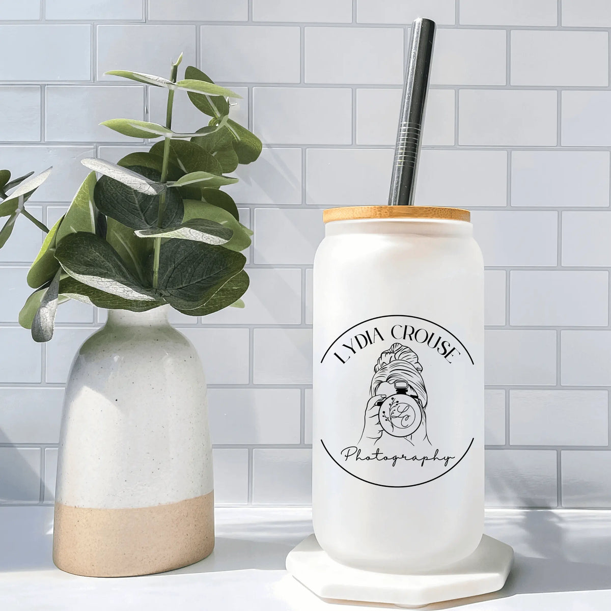 Winks Design Studio Lydia Crouse frosted glass beer glass with elegant design and clear branding, showcasing a stylish drinking vessel.