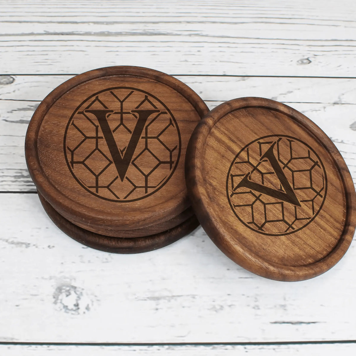 Verdigris wooden engraved coasters by Winks Design Studio, LLC, featuring detailed carved designs on natural wood surfaces.