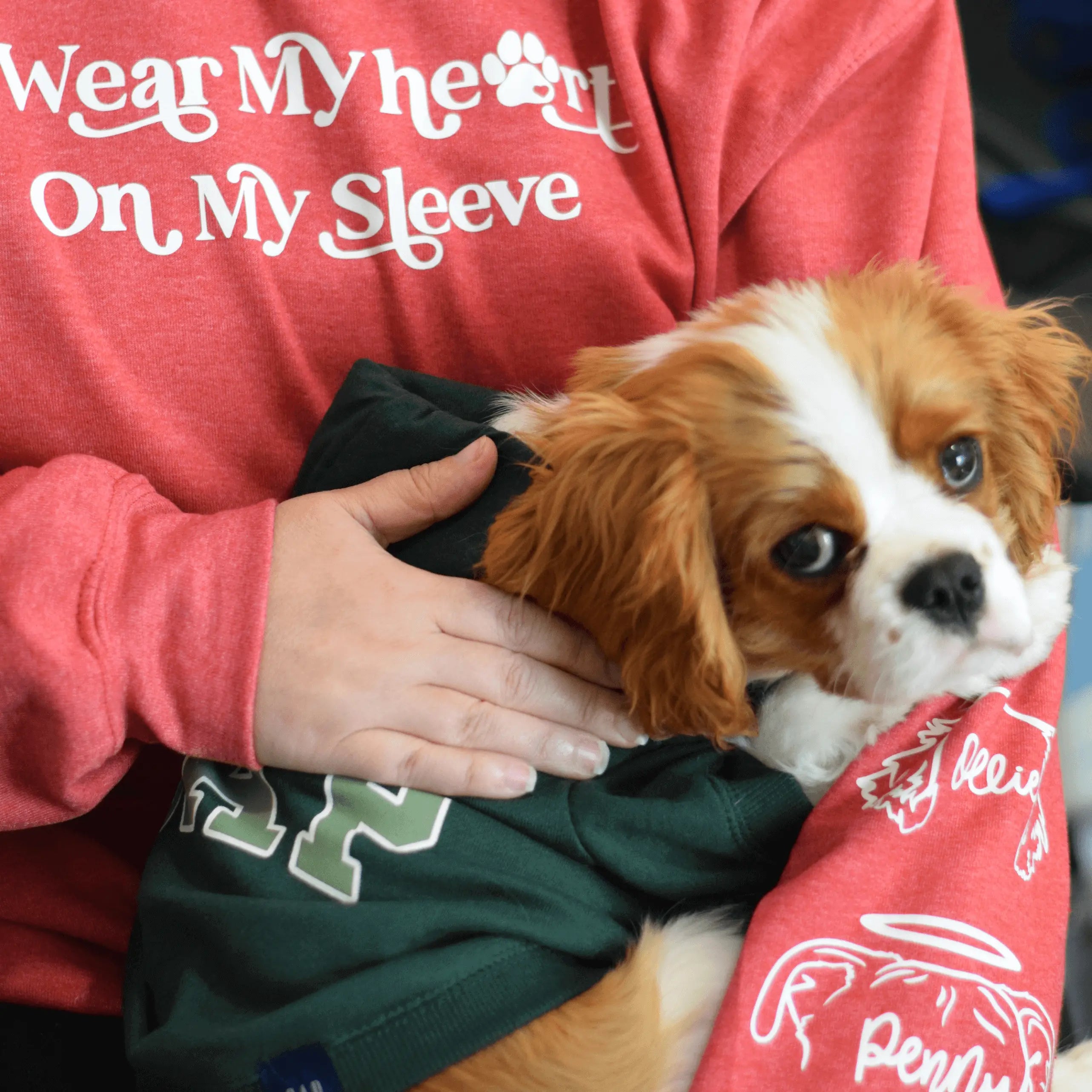 Heather royal crewneck sweatshirt by Winks Design Studio, LLC featuring the phrase "I Wear My Heart on My Sleeve" printed on the front.
