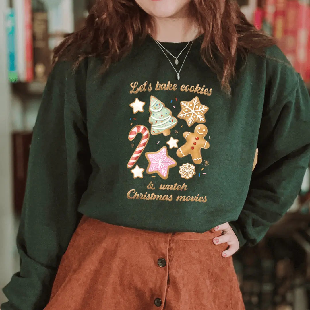 Pink Let’s Bake Cookies crewneck sweatshirt by Winks Design Studio, LLC featuring a cozy, casual design with baking-themed graphics.