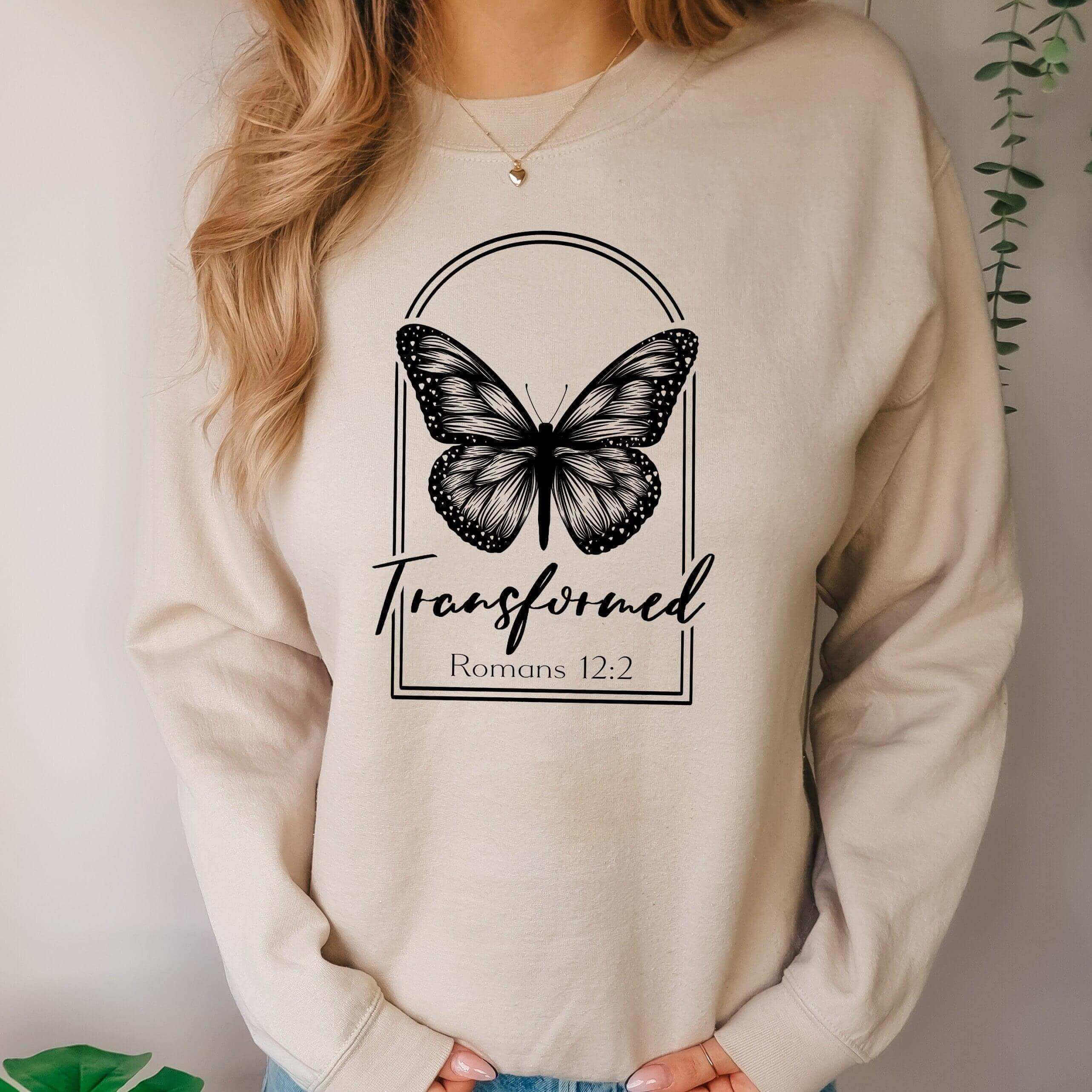 Winks Design Studio Butterfly Crewneck sweatshirt featuring a butterfly design and Roman 12:2 quote on soft fabric.