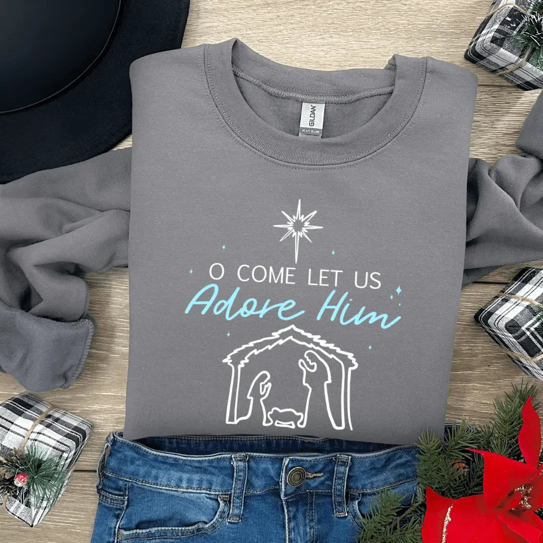 Winks Design Studio LLC O Come Let Us Adore Him Nativity crewneck sweatshirt with festive holiday design on a cozy crewneck shirt.