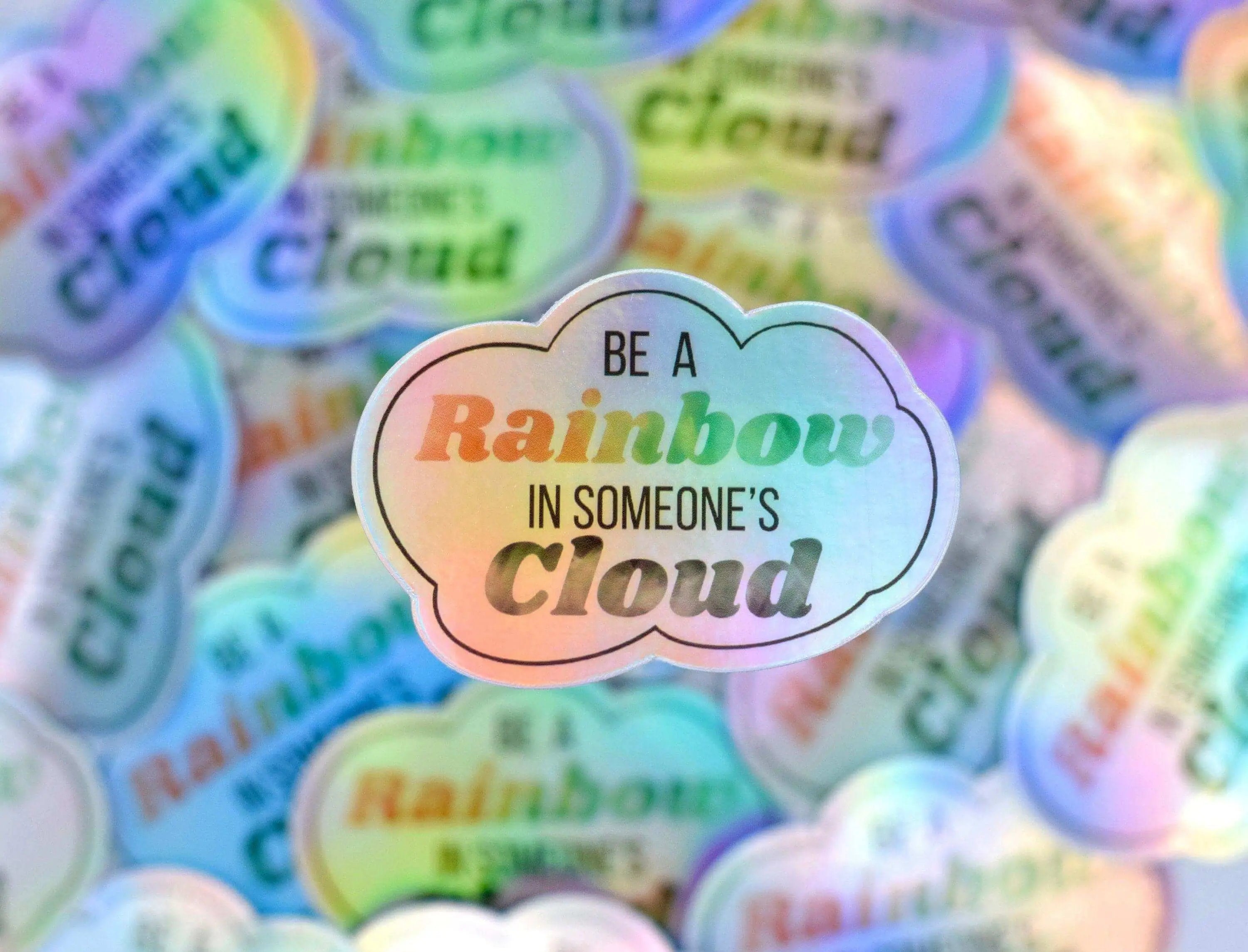 Decorative sticker featuring a rainbow and cloud design from Winks Design Studio, LLC, with vibrant colors for uplifting decor.