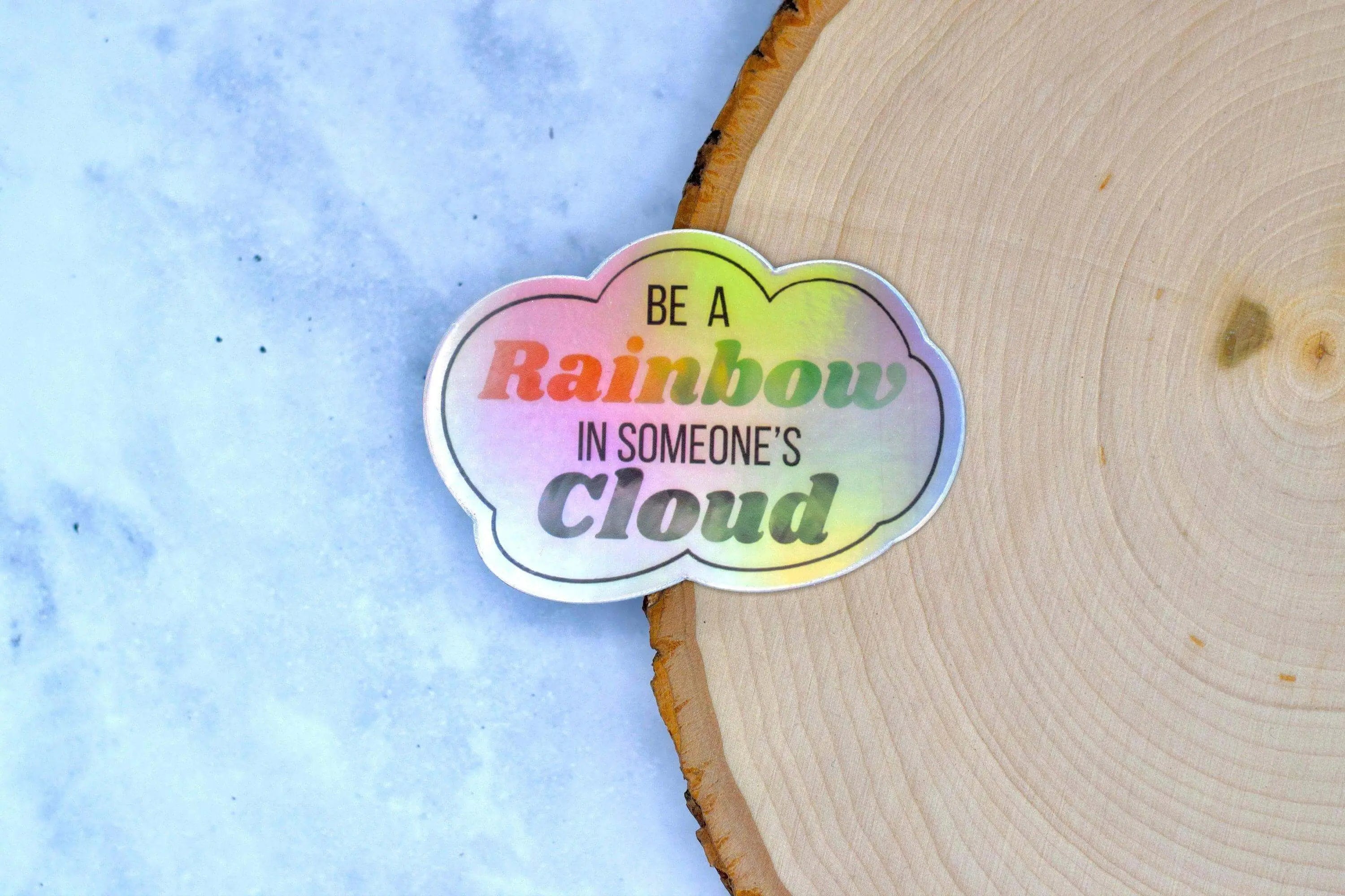 Decorative sticker by Winks Design Studio featuring a colorful rainbow with clouds, inspiring positivity and charm.