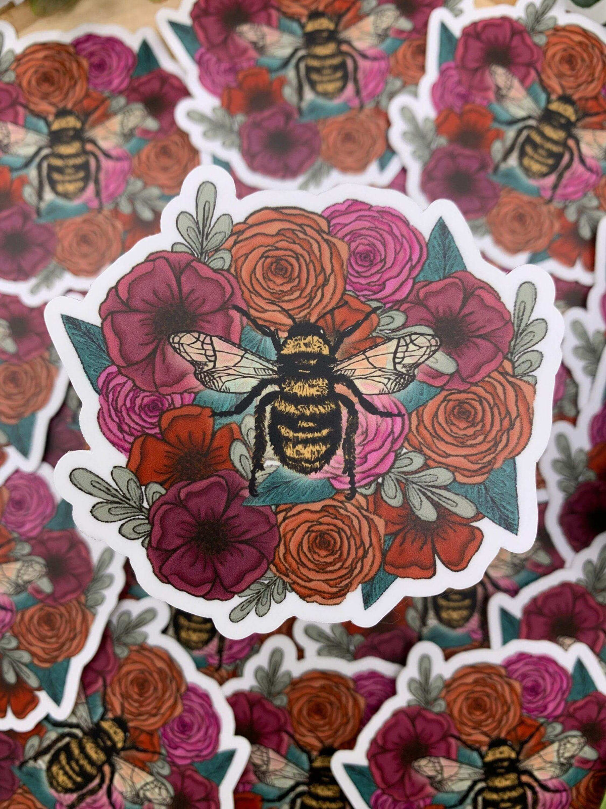 Decorative vinyl sticker featuring a bee on colorful flowers, designed by Winks Design Studio, LLC.