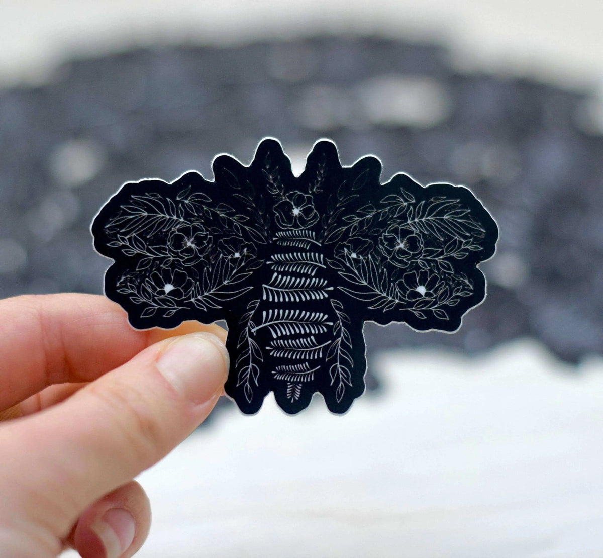 Decorative flower bee vinyl sticker by Winks Design Studio LLC featuring a colorful bee and floral design on clear backing.