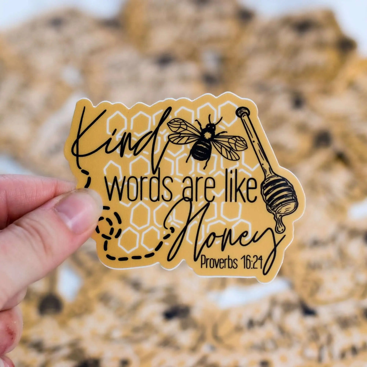 Decorative sticker featuring the phrase "Kind words are like honey" from Winks Design Studio, LLC, with honeybee illustrations.