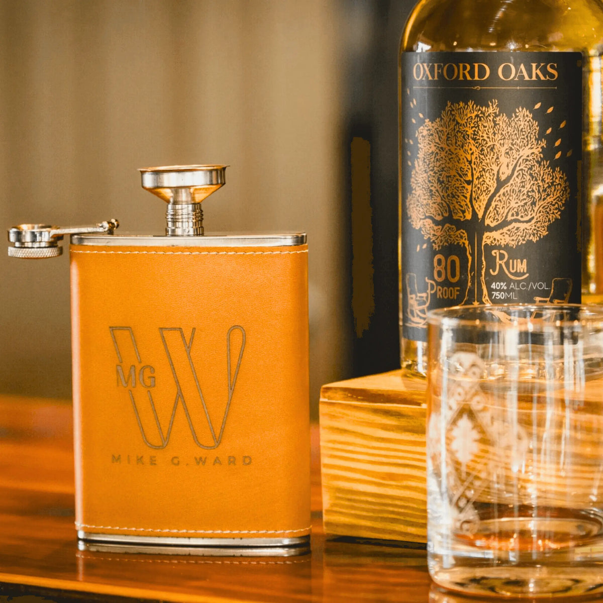 Winks Design Studio LLC Oxford Oaks Distillery 8oz metal flask with logo and engraved design, perfect for carrying beverages.