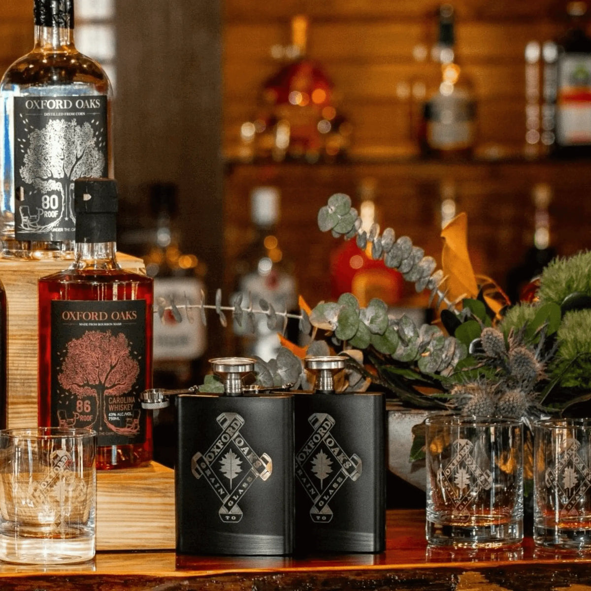 Winks Design Studio LLC Oxford Oaks Distillery 8oz metal flask with logo, sleek and portable for carrying beverages.