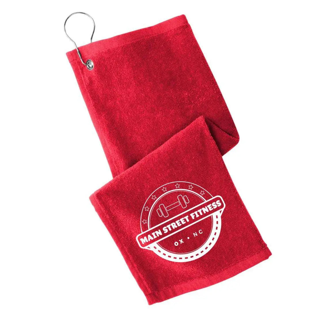 Black Main Street Fitness golf towel by Winks Design Studio, LLC, featuring a soft fabric with a woven logo detail.