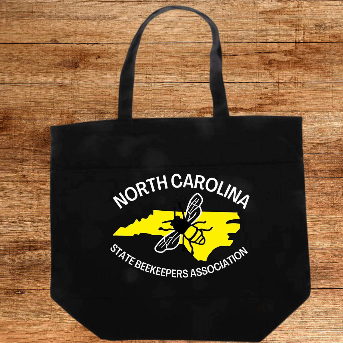 Winks Design Studio LLC NCSBA tote handbag with multiple pockets, natural-colored fabric and sturdy handles for everyday use.