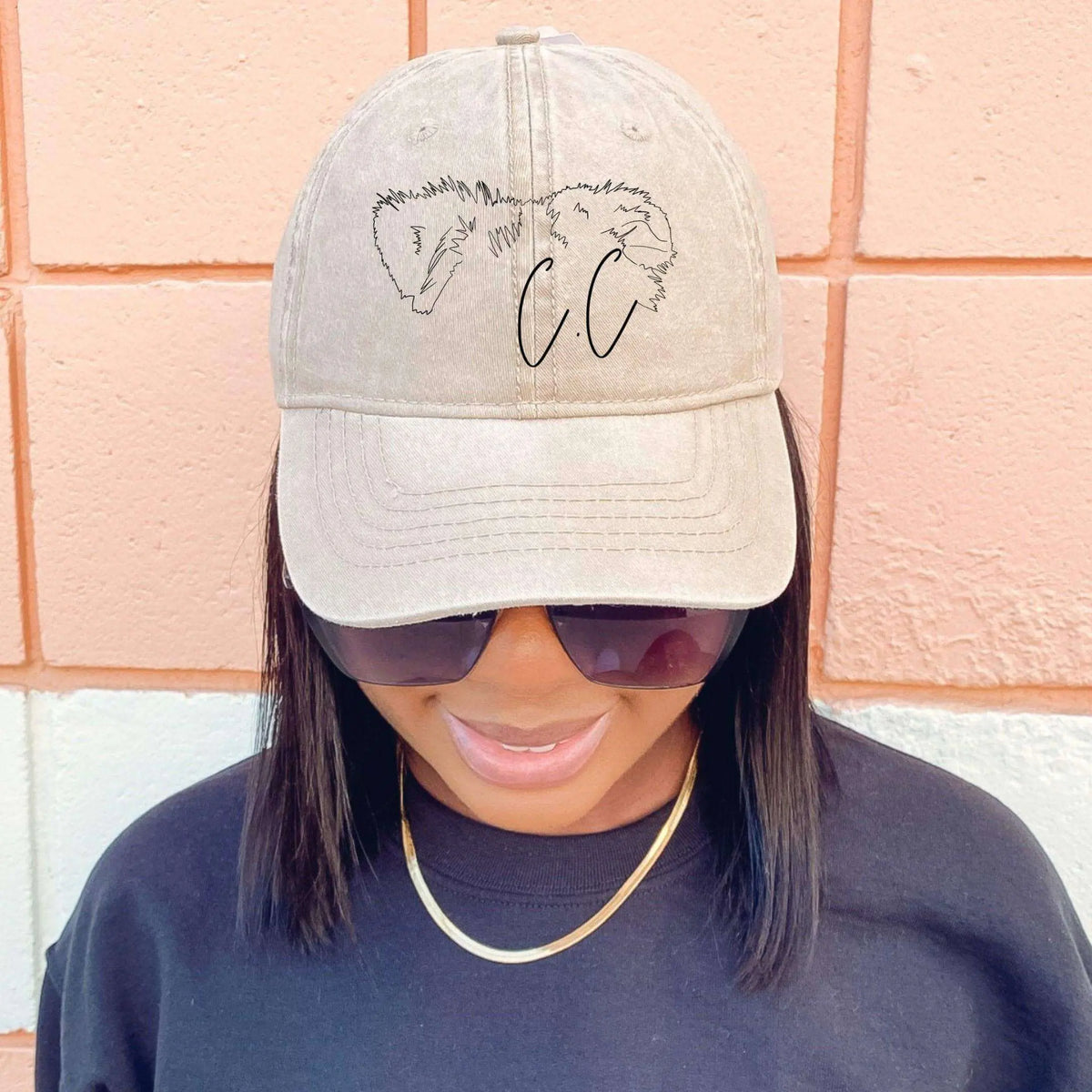 Black twill hat by Winks Design Studio with custom pet ear outline embroidery on the front.