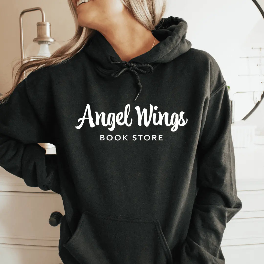 Pink Oxford Crokinole Club hoodie by Winks Design Studio with angel wings and bookstore graphic, displayed on a horizontal layout.