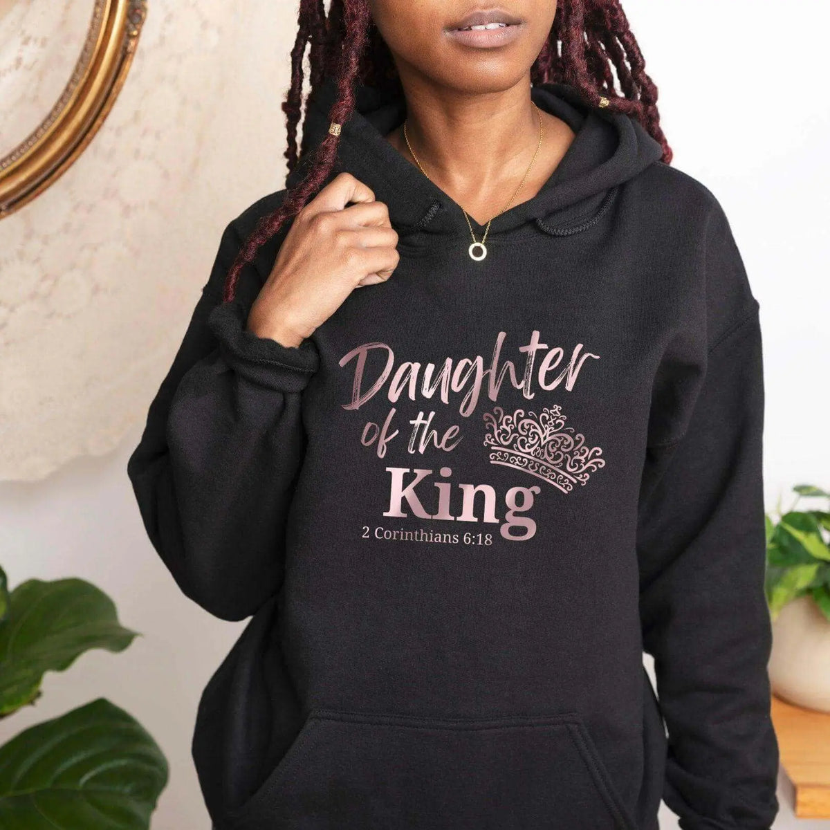 Winks Design Studio LLC Daughter Of The King front pocket hoodie in black with white lettering, casual style, close-up view