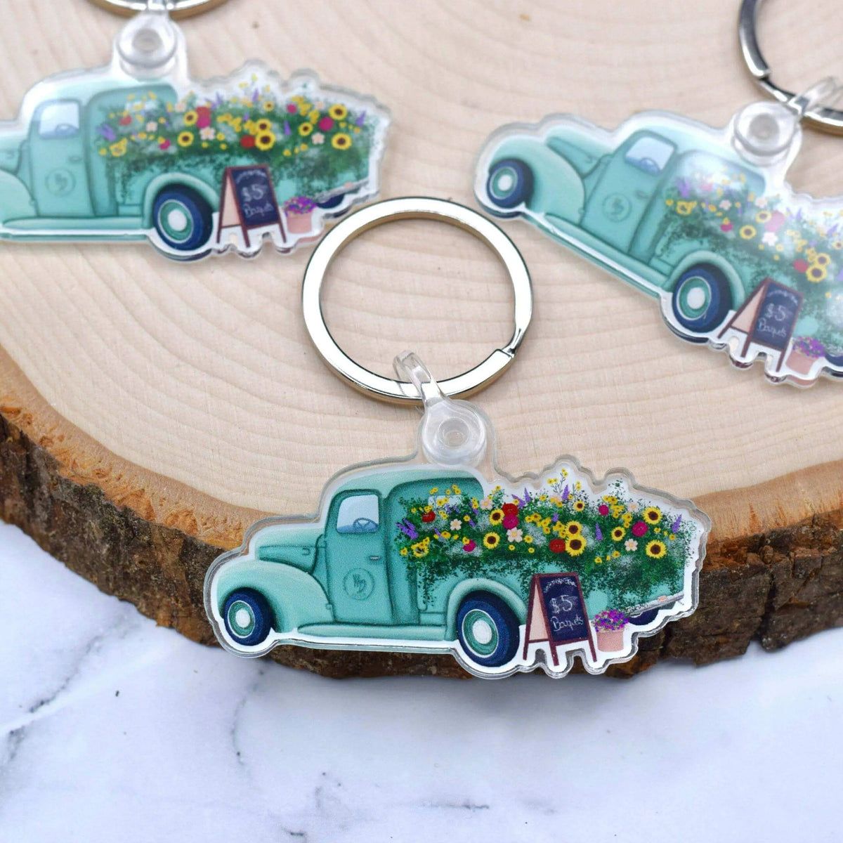 Antique flower truck keychain from Winks Design Studio, LLC featuring a vintage-style flower truck design.