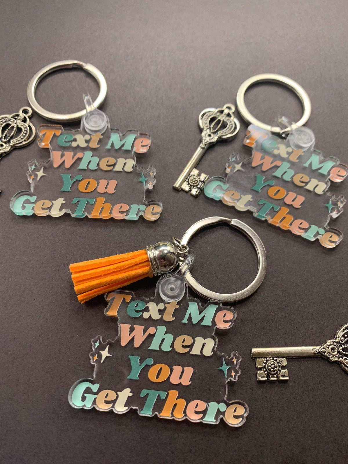 Drive Safe Keychain by Winks Design Studio LLC featuring the message "Text Me When You Get There" on a metal keychain.