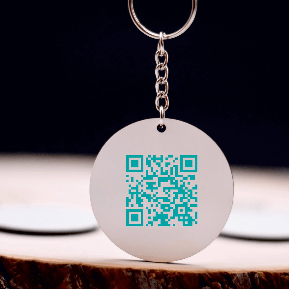 Winks Design Studio LLC Lydia Crouse logo keychain with a sleek design and metal keyring on a white background.