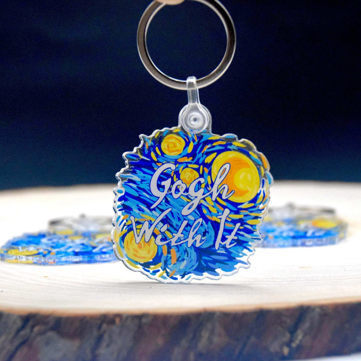 Starry Night acrylic keychain by Winks Design Studio, LLC featuring a vibrant night sky scene with stars and swirling patterns.