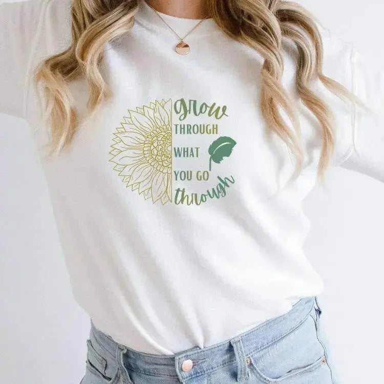 Winks Design Studio long sleeve shirt with "Grow Through What You Go Through" slogan, black fabric, and comfortable fit.