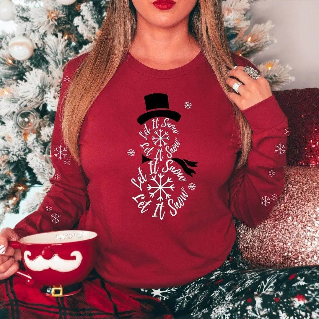Winks Design Studio LLC Let It Snow long sleeve shirt with festive snowflake print on white fabric.
