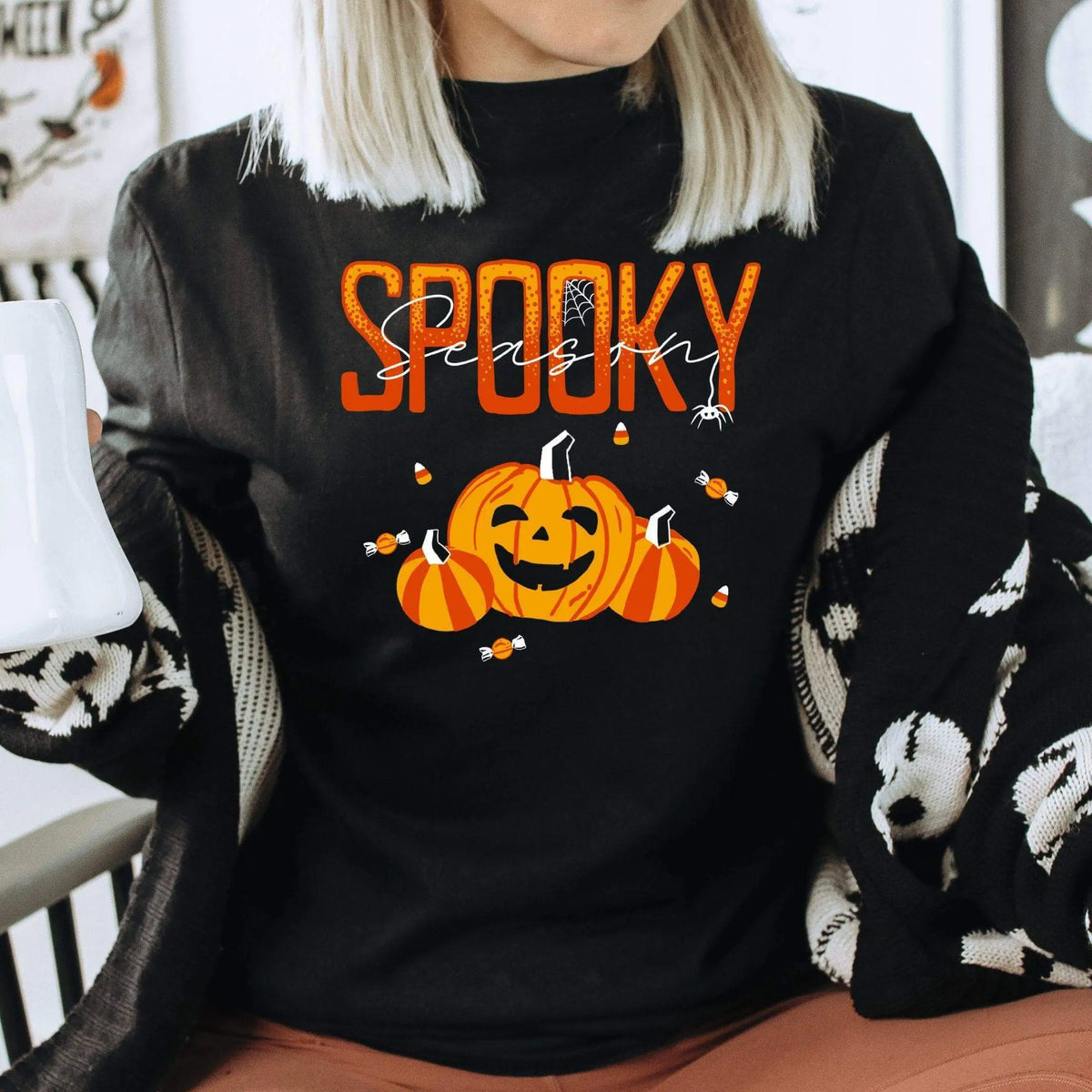 Winks Design Studio LLC Spooky Season long sleeve shirt with Halloween-themed design, black fabric, and comfortable fit.