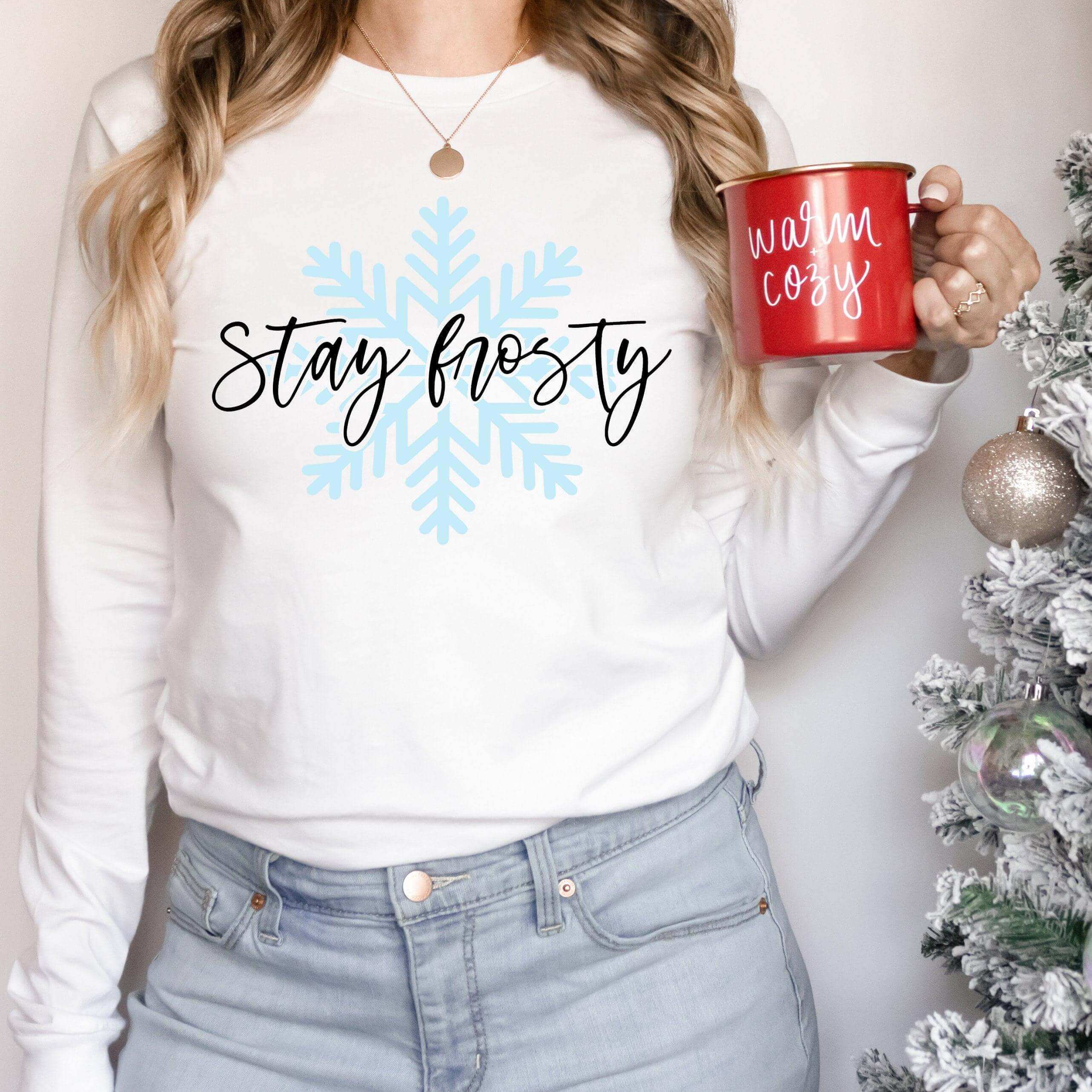 White snowflake design on a navy blue long sleeve shirt by Winks Design Studio LLC, showcasing a cozy winter style.
