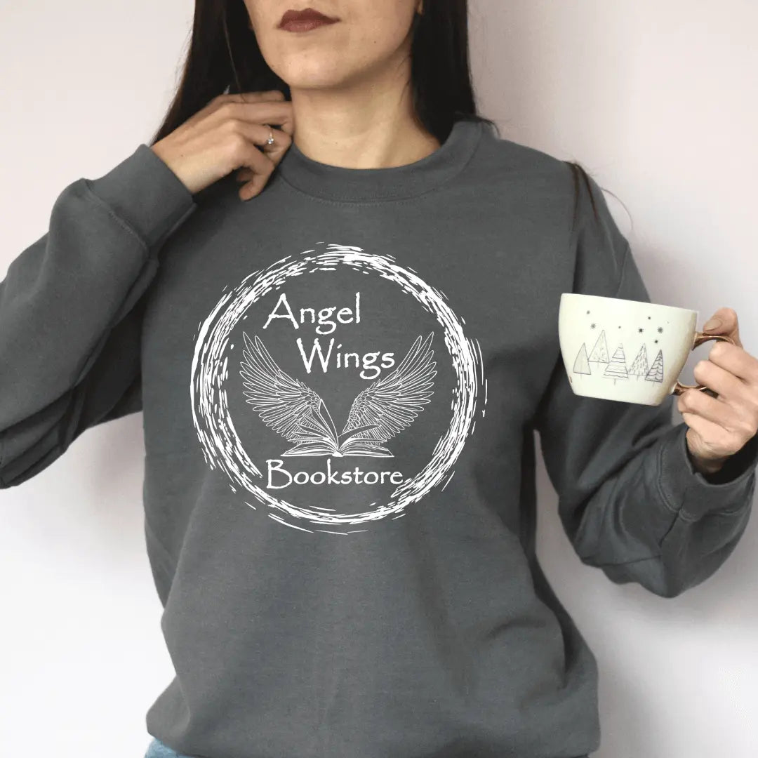White long sleeve shirt by Winks Design Studio featuring angel wings and bookstore circular design on the front.