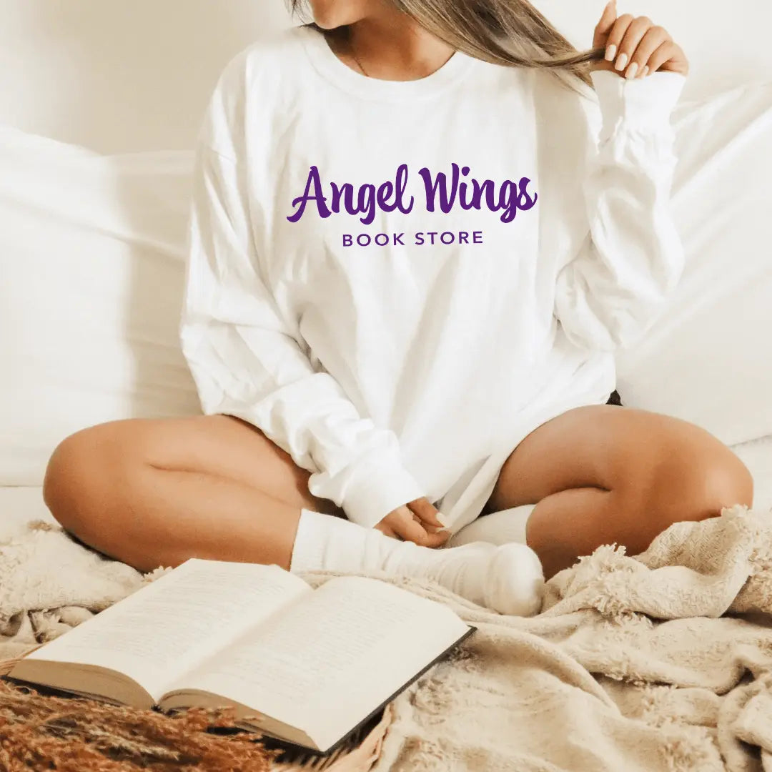 White Angel Wings long sleeve shirt by Winks Design Studio, LLC featuring a horizontal bookstore design on the front.