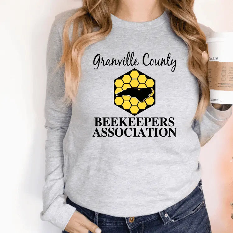 White long sleeve shirt by Winks Design Studio LLC with a central chest image, casual and comfortable for everyday wear.