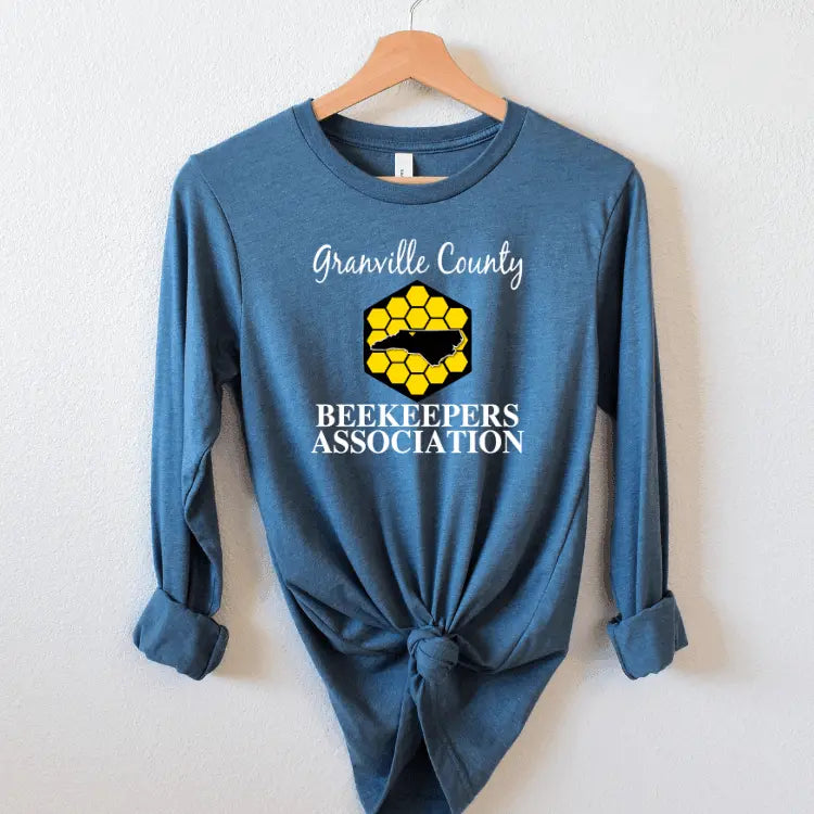 White long sleeve shirt from Winks Design Studio, LLC featuring a GCBA center chest design, displayed on a mannequin.