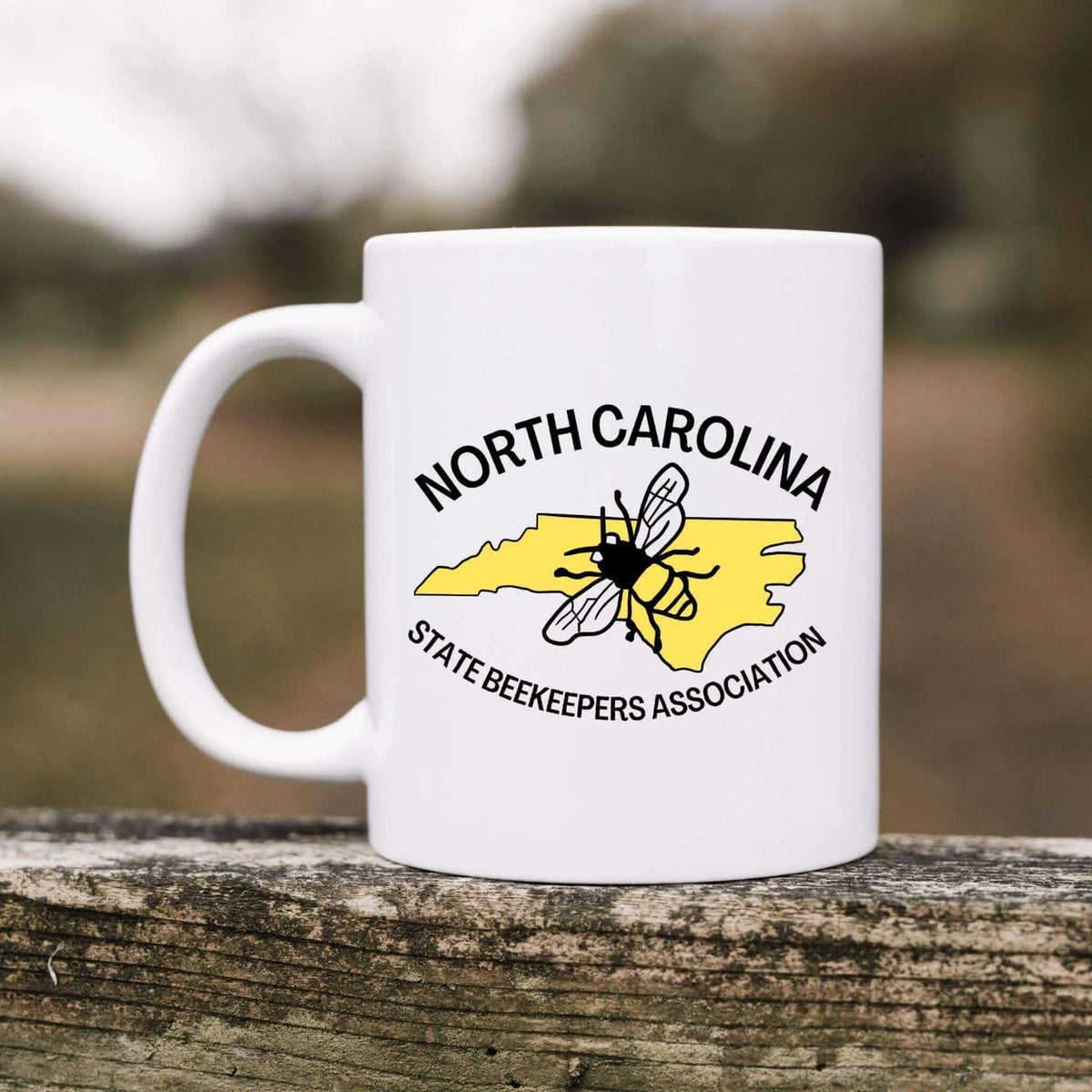 Winks Design Studio LLC NCSBA ceramic mug with a white exterior and colorful design, perfect for coffee or tea drinking.