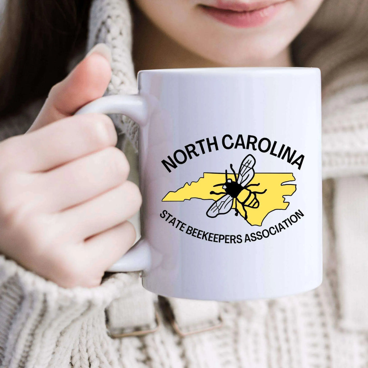 Winks Design Studio LLC NCSBA ceramic mug with a white handle and colorful design, perfect for coffee or tea.