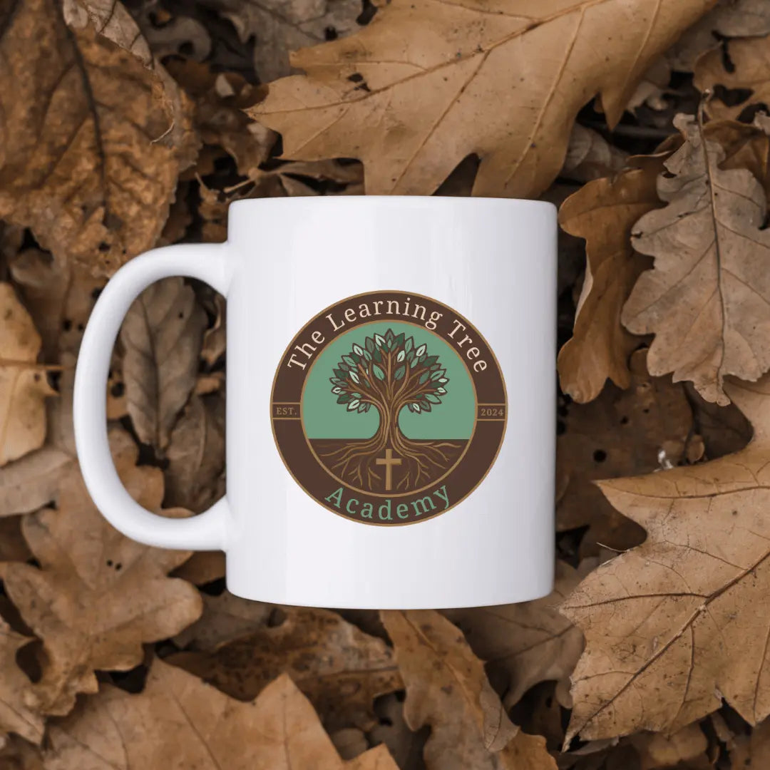 Winks Design Studio LLC ceramic mug featuring The Learning Tree Academy logo, white ceramic with colorful design.